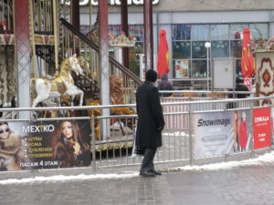 Close up of Dad by carousel - this was before we bought his new hat and scarf.