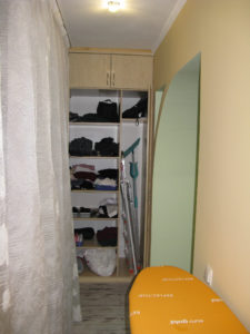 The closet on the balcon next to our bedroom with shelves and a tall storage place for mops and all with a step ladder to reach taller shelves