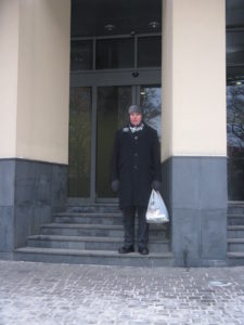 Here is Carl all bundled up outside the entrance to our building. Notice his nice warm hat with ear flaps and his new scarf. The bag holds the dough I made for making rolls for our mission leader luncheon.