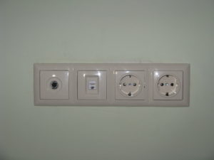 A four outlet section in our bedroom - the first is a phone or internet outlet, not sure what the second is, but the last two our plugs.