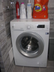 Here is our cute little washing machine. It has many cycles and holds two bath towels or the equivalent thereof - not much.