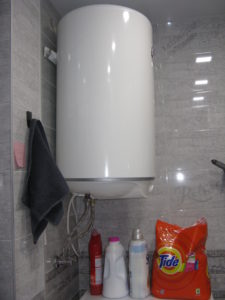 Here is the water heater hanging over our washer. You can also see we have Tide - there is only one variety but it works fine. The other bottles are fabric softener, Vanish, and toilet cleaner.