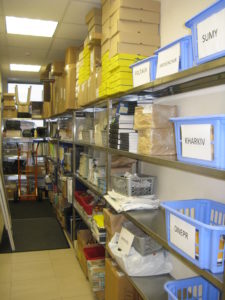 This is the back hall where many of our mission supplies are stored. One of the big jobs I have yet to take on is the inventory - UGH! At the end of the hall is a door to the stairs that we have to use when the elevator is out. We pray for the elevator to work so we don't have to climb all the stairs to our fifth floor office. By the way, the blue boxes are for mail for the missionaries and the open shelves are where we store all the boxes they get until I get them mailed out to the missionaries. 