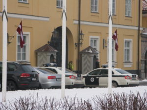 Can you see the entrance with the guard house on the right? There is a matching one on the left and a police man patrolling the front.