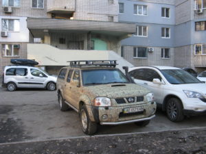 Coming back this car was parked outside our playground as we walked through to our apartment (that is the entrance to our apartment building in the background). It is like an army camouflage car. I see other interesting paint jobs but I usually don't have my camera near by. 
