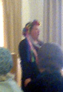 Here is a close up of the same woman where you can see the flowers in her head dress and the ribbons hanging down. It is taken with my phone and not a great picture but hopefully gives you a flavor of it.