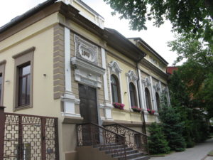 Great house. We pass this house often and I have always liked it - it is neat and clean and well taken care of. The sign over the door says 1890. There are flower boxes on each upstairs window and they have lovely flowers in them.