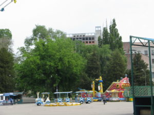Closeup of the amusement area with a small train and blow up boat.