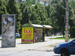 Here is a close up of the stop and yes that is advertising a taxi.