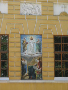 A close up of the picture on the wall outside.