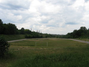 A large athletic field with a track of sorts going around it.