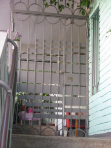 As we leave our apartment building we have a locked gate to go through. One the inside there is just a latch to open but from the outside you have to know the code to get in. Here is our gate into our building.