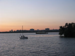 There is a small boat and a much larger one in the distance.