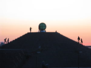 We have been to the top of this to see this ball memorial but I like the figures climbing up with the sunset behind it.