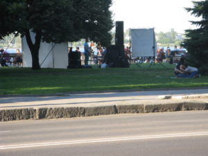 Saxophone player - kind of in the middle between the screens - he is standing up.