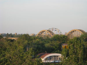 You can see the ferris wheel with the arches of the southern bridge behind it.